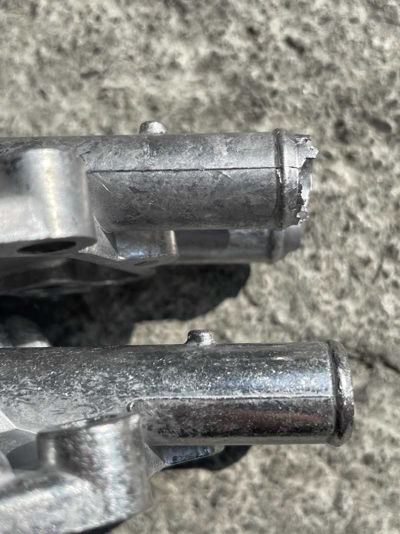 Flash left on the end of a raw aluminum casting